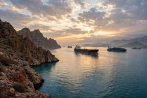 Oil tankers sail through the Strait of Hormuz at dawn