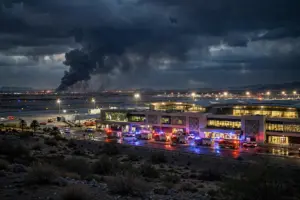Emergency responders and smoke at a Saudi airport terminal at night following Houthi-claimed attacks on Abha and Riyadh airports