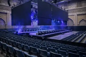 An empty esports arena in Jeddah, Saudi Arabia, with dark LED screens and dramatic lighting ahead of the postponed FIFAe Finals 2026.