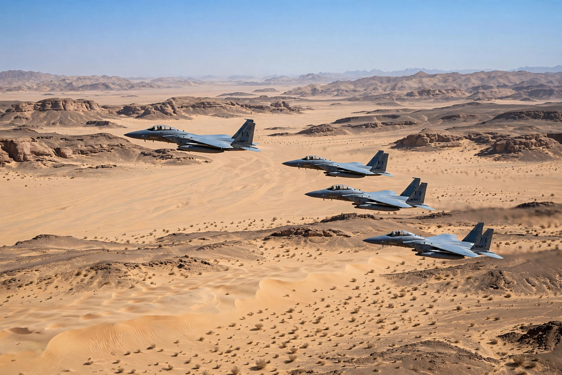 Fighter jets flying over a desert landscape in Saudi Arabia