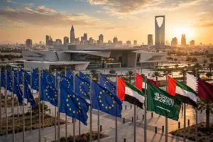 European Union and Gulf state flags flying in front of a summit conference building in Riyadh, Saudi Arabia, at sunset