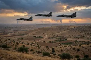 Fighter jets fly over dry hills and farmland in southern Syria at dusk