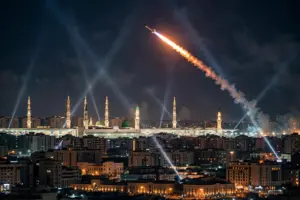 Interceptor missile streak lights up the night sky over Madinah, Saudi Arabia, near the illuminated minarets of the Prophet's Mosque
