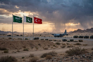 Military transport aircraft and soldiers on a desert airbase as Pakistan and Türkiye deploy forces to Saudi Arabia under the Makkah Defence Alliance