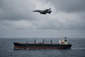 US fighter jet flies over the Panama-flagged bulk carrier M/V Ocean Molica in the Gulf of Oman during US blockade enforcement against Iranian ports