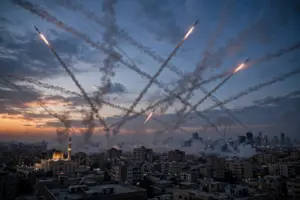Air defence interceptor missile trails over a Middle Eastern city skyline at dusk