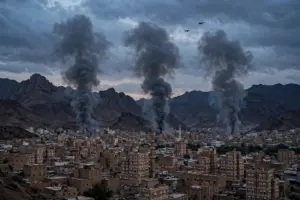 Smoke rises over Sanaa, Yemen, as government forces say they struck Houthi targets across the country
